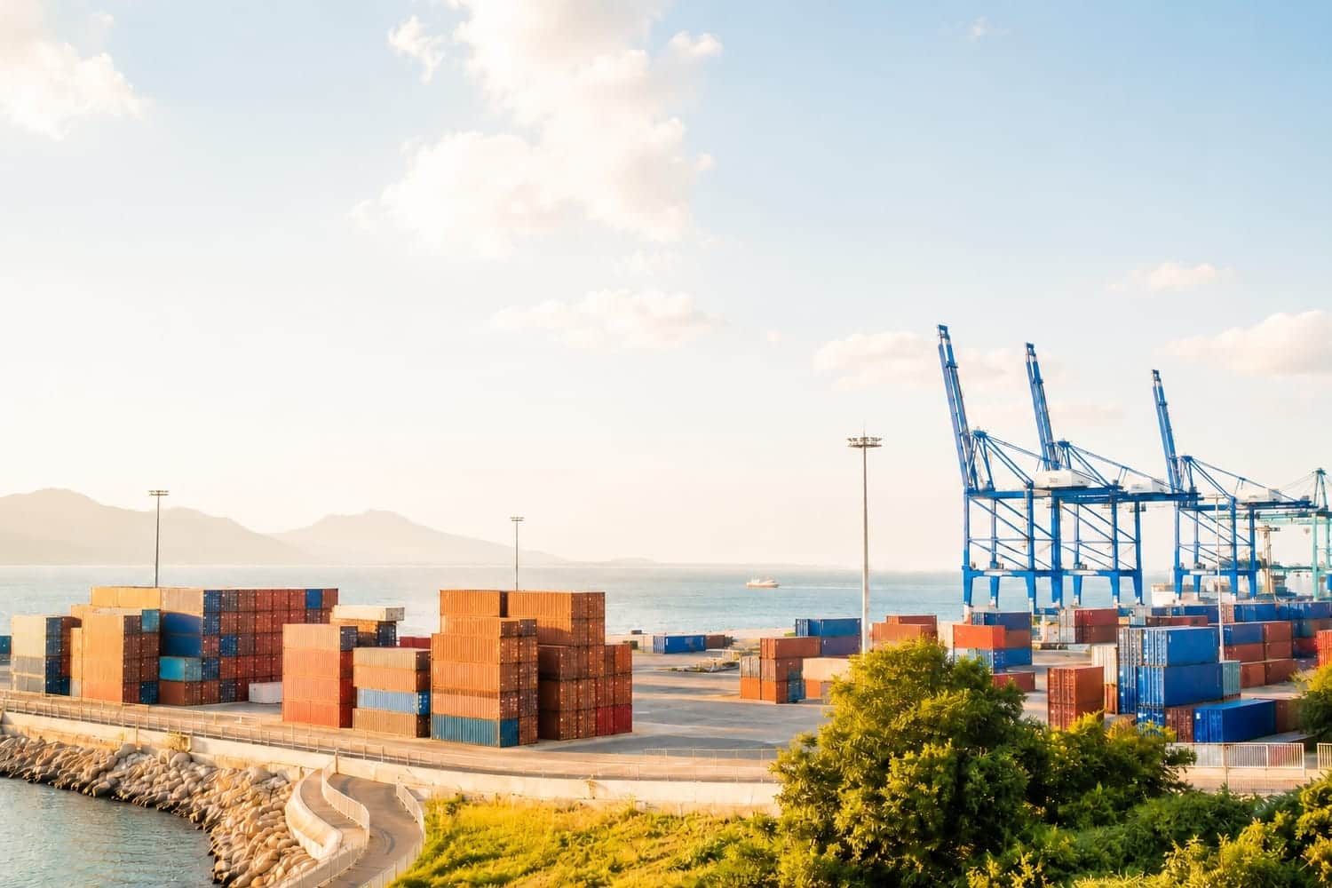 Container port at bright morning with colorful containers, sea and sky